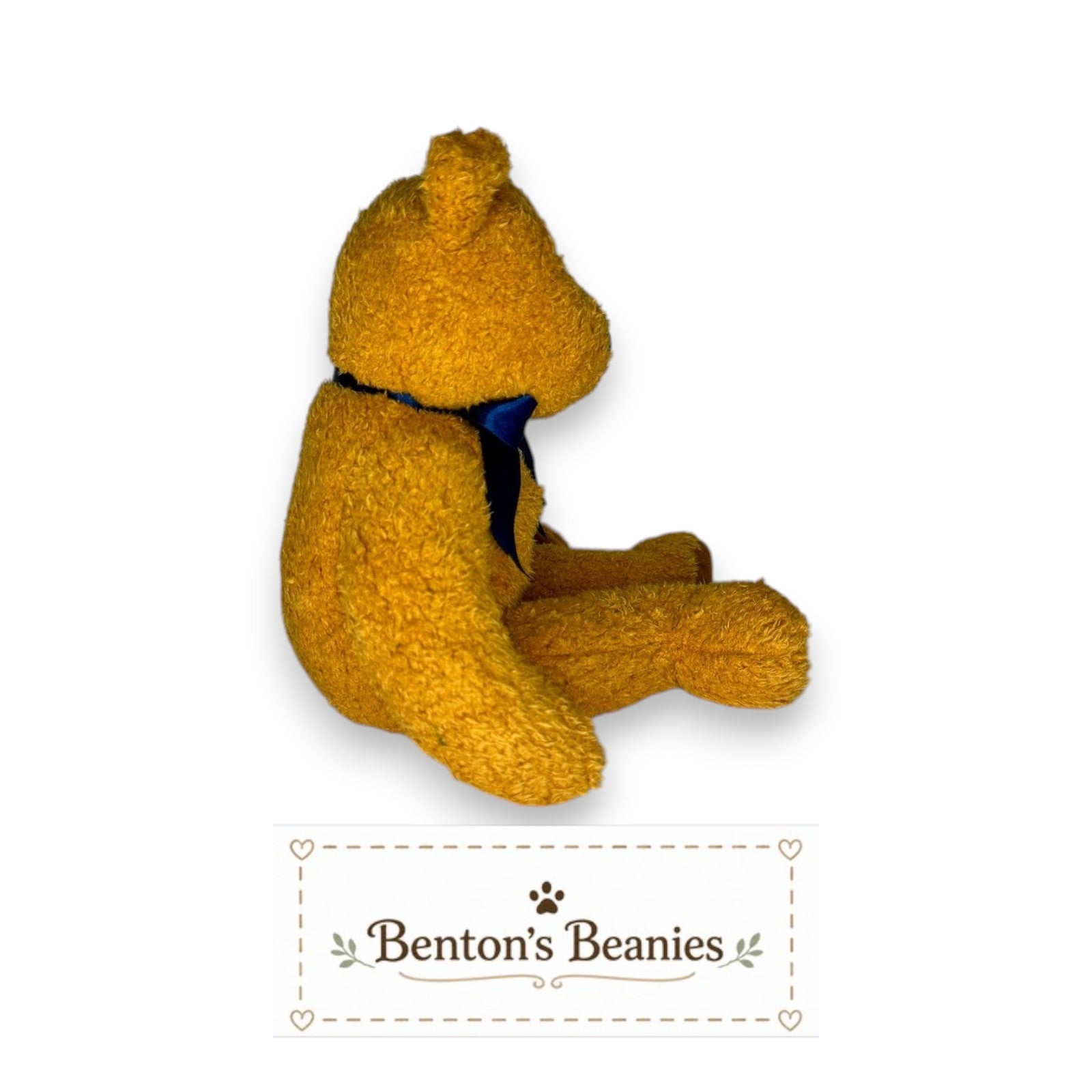 Benton's Beanies Fuzz the Bear Ty Beanie Buddy, golden-brown plush with fuzzy texture and navy satin ribbon.