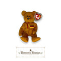 Benton's Beanies Germania the Bear Ty Beanie Baby with golden-brown plush, red ribbon, and German flag chest patch.