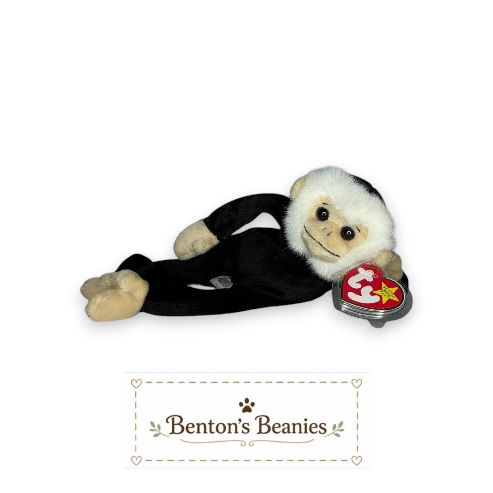 Benton's Beanies Mooch the Spider Monkey TY Beanie Baby plush toy with white fur and black outfit, lying down.