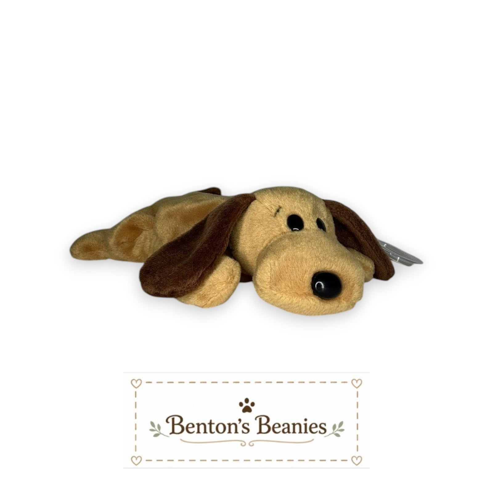 Benton's Beanies tan plush dog with floppy brown ears and black eyes, lying down.