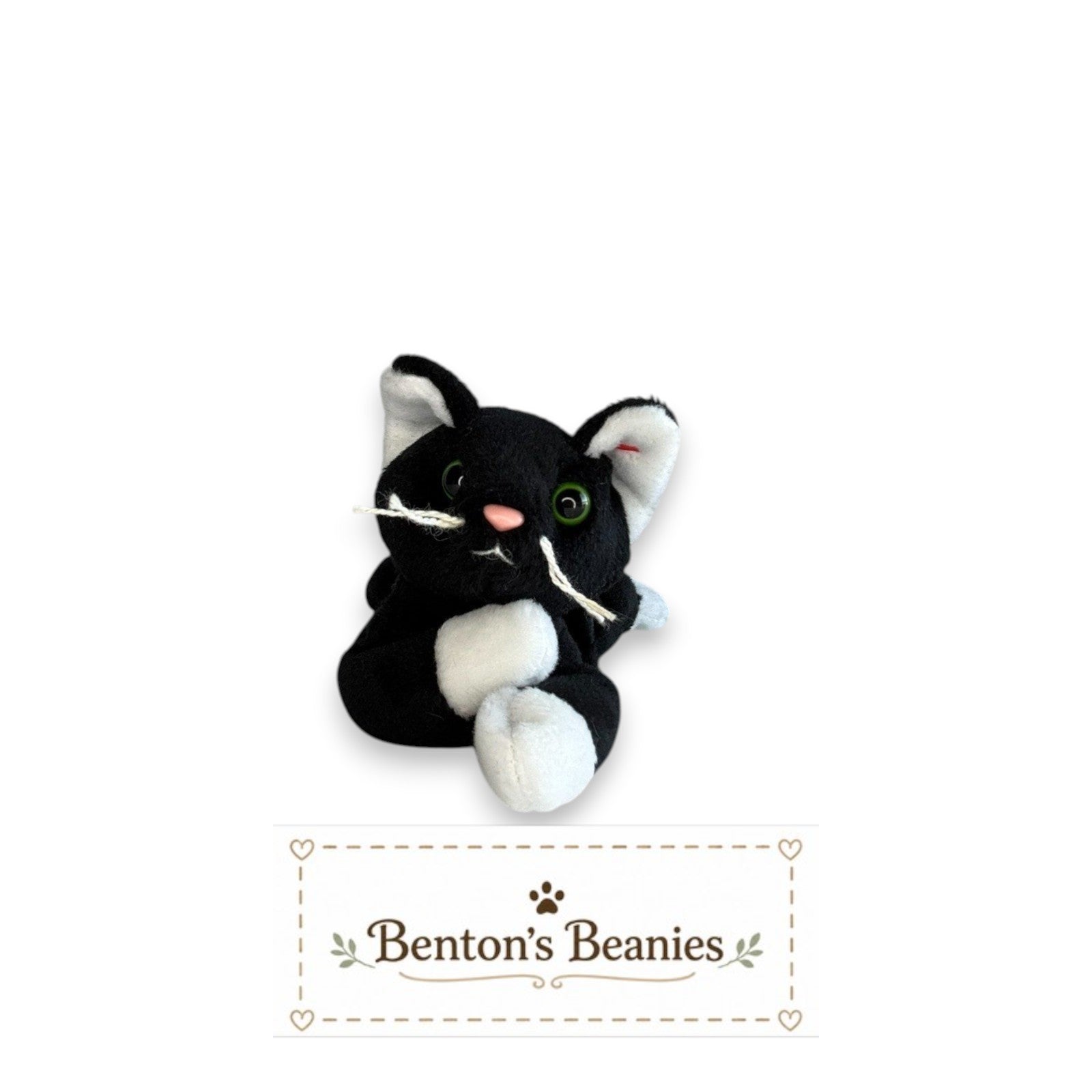 Benton's Beanies Zip the Cat Ty Beanie Baby with black and white plush fur, green eyes, and original heart tag
