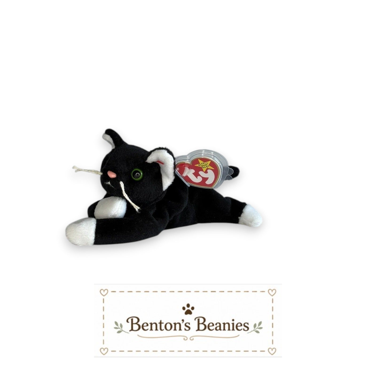 Benton's Beanies Zip the Cat plush toy with black and white fur, green eyes, and original Ty heart tag.