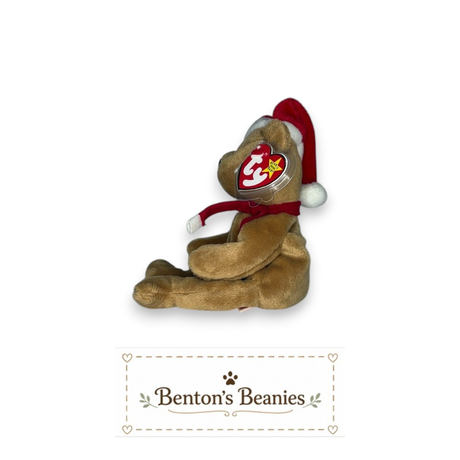 The Beanie Center 1997 Holiday Teddy Beanie Baby plush toy wearing a red Santa hat and scarf. Mint condition.